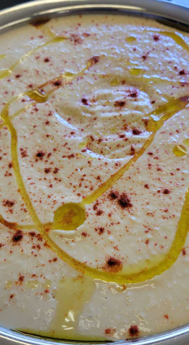 Creamy soup drizzled with olive oil and dusted with red spice
