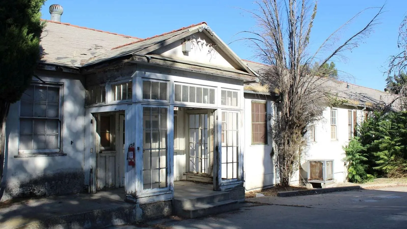 Historic Stony Brook Retreat sanatorium building with glass-paneled entry porch