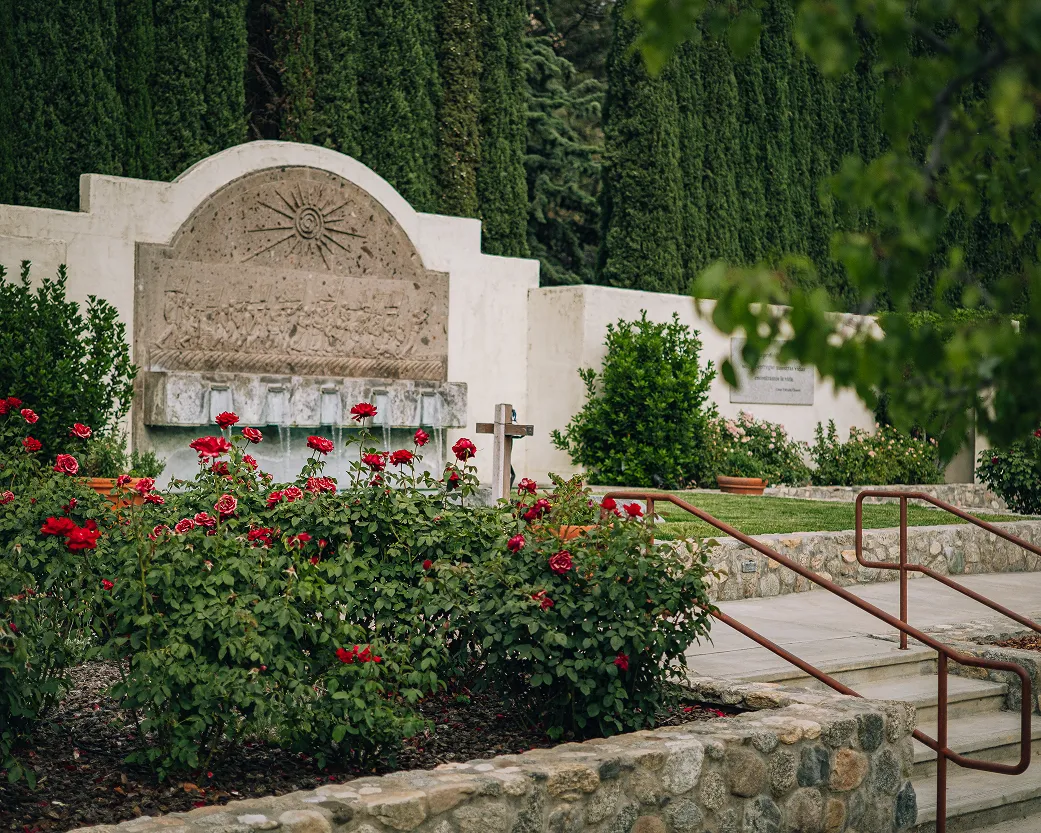 Rose garden and arched stone fountain at the César Chávez memorial garden, National Chavez Center