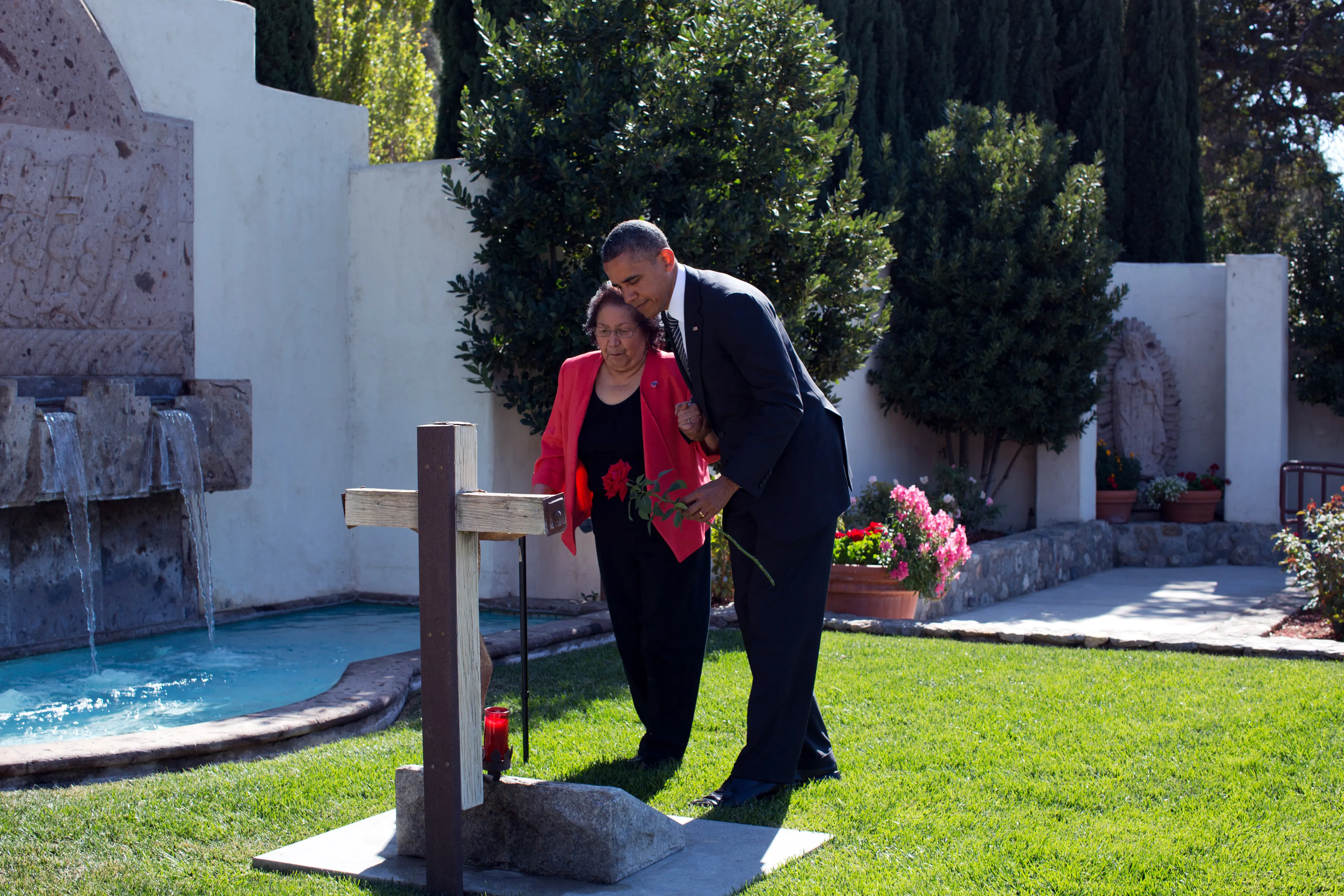 Helen Chávez and President Obama placing a rose at César Chávez's grave during the 2013 monument dedication