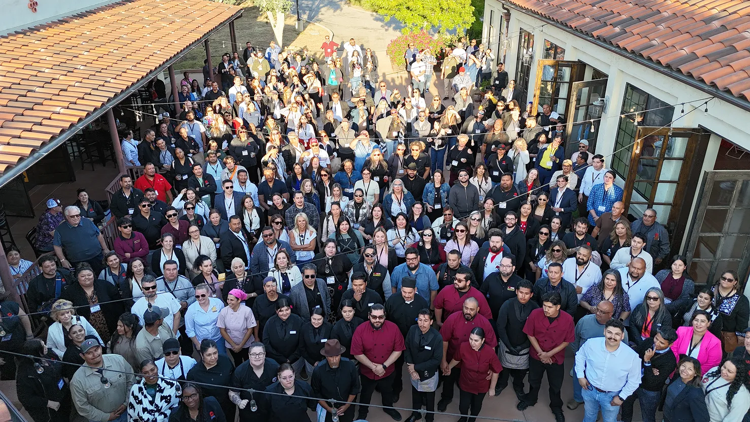 Large group of guests gathered in the tiled courtyard at Villa La Paz