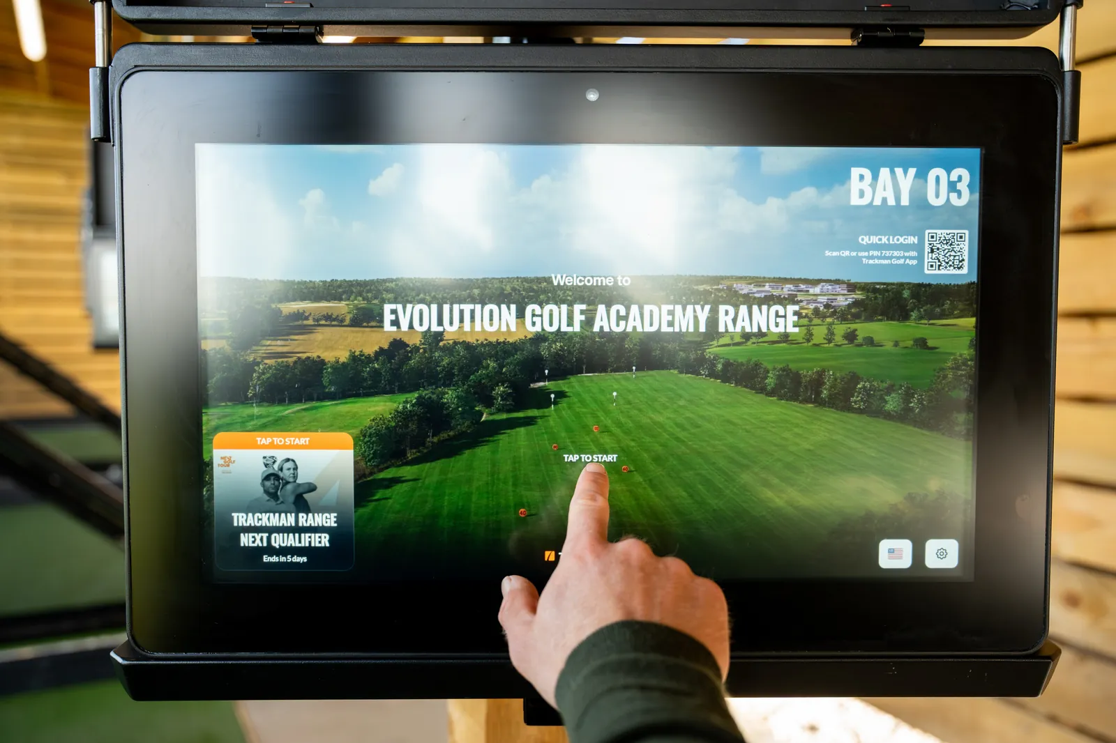 Coach selecting a session on the TrackMan screen in Bay 03 at Evolution Golf Academy in Derbyshire.
