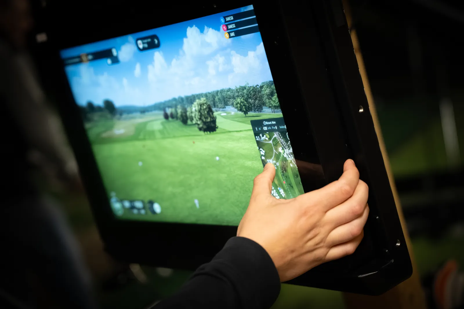 TrackMan launch monitor screen displaying a virtual course during a golf coaching session.