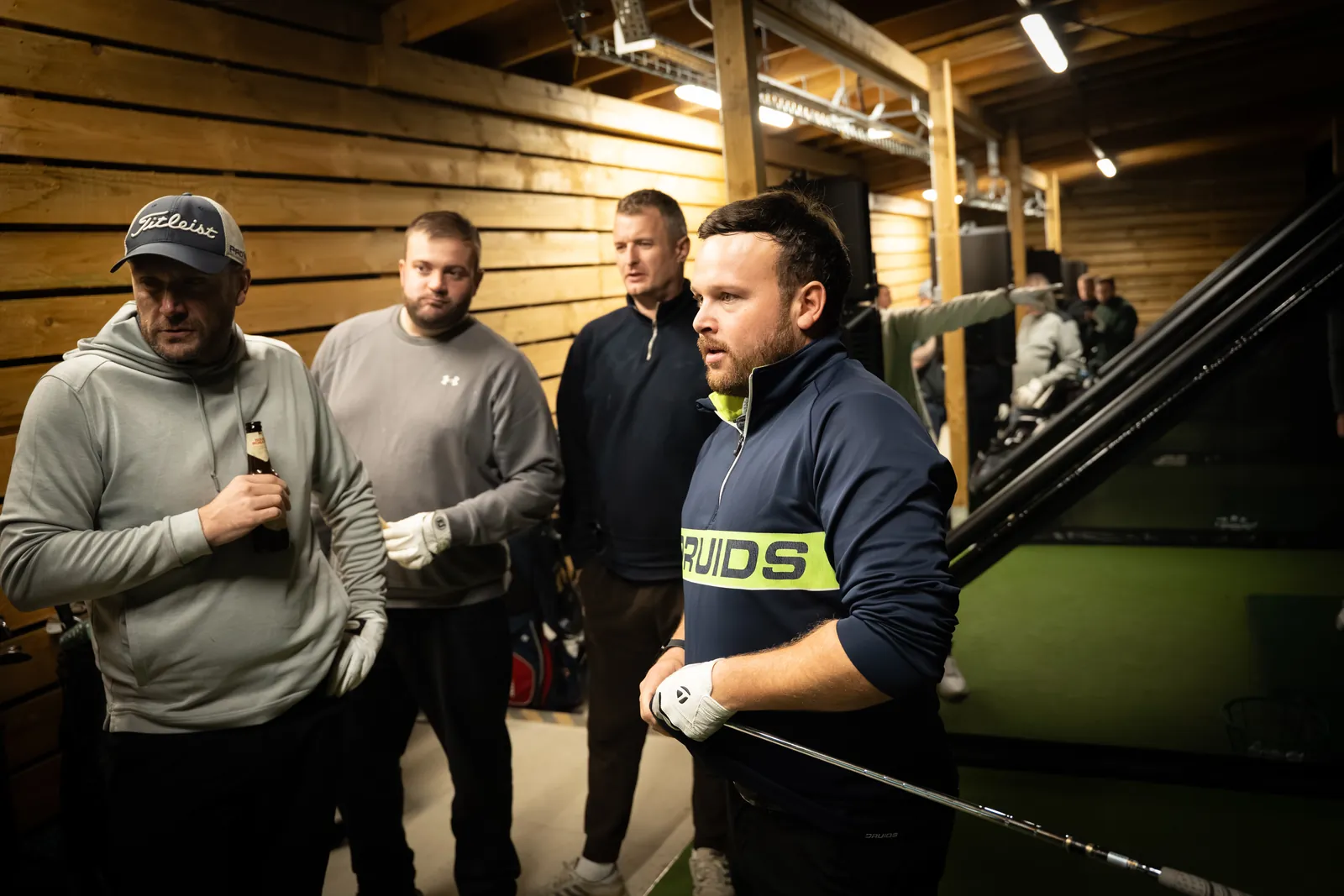 Players gathered inside the Evolution Golf Academy bays in Derbyshire.