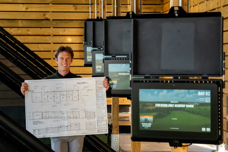 Coach reviewing custom fitting data and TrackMan numbers with a student.