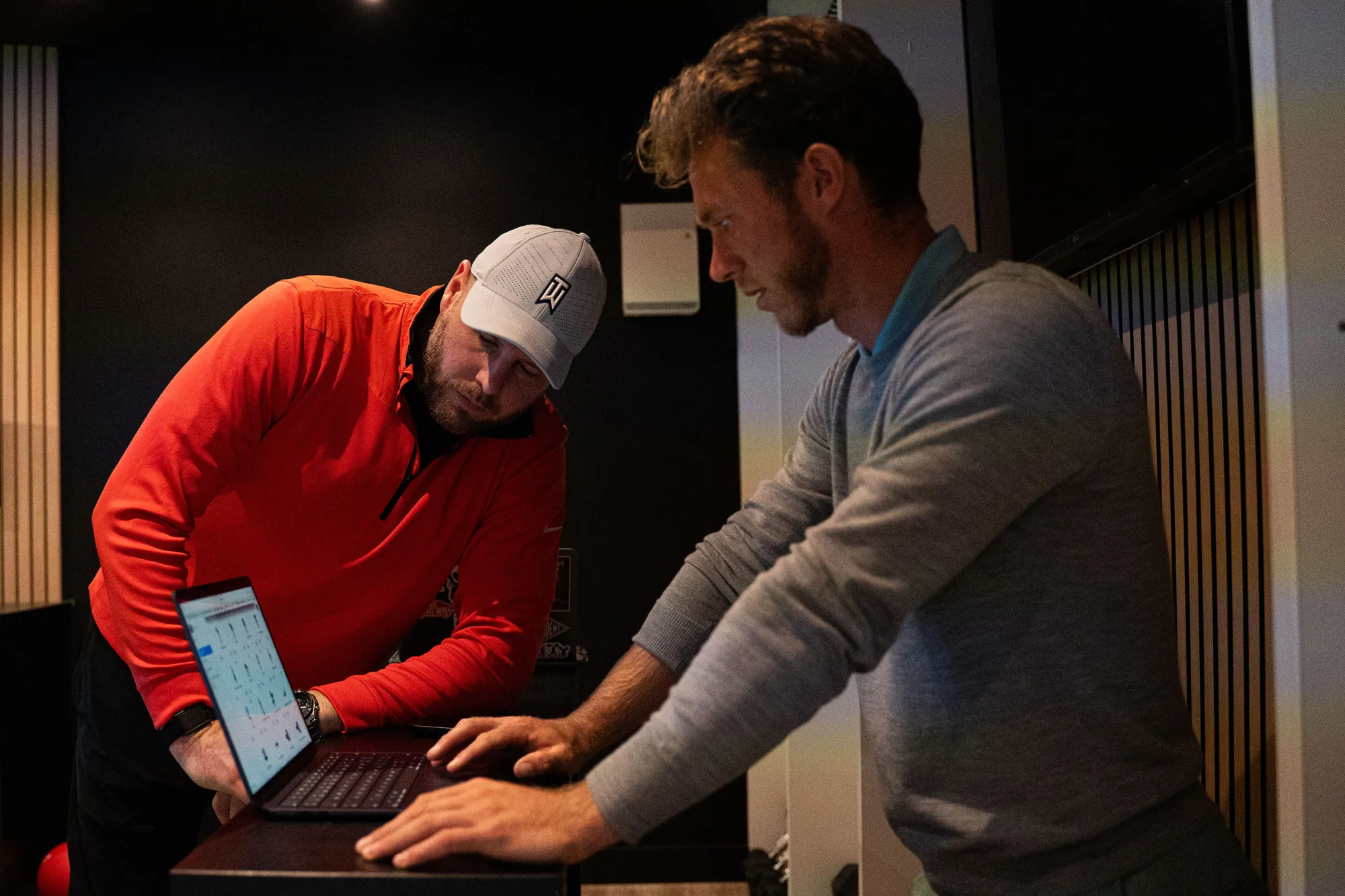 Reviewing TrackMan numbers on a laptop