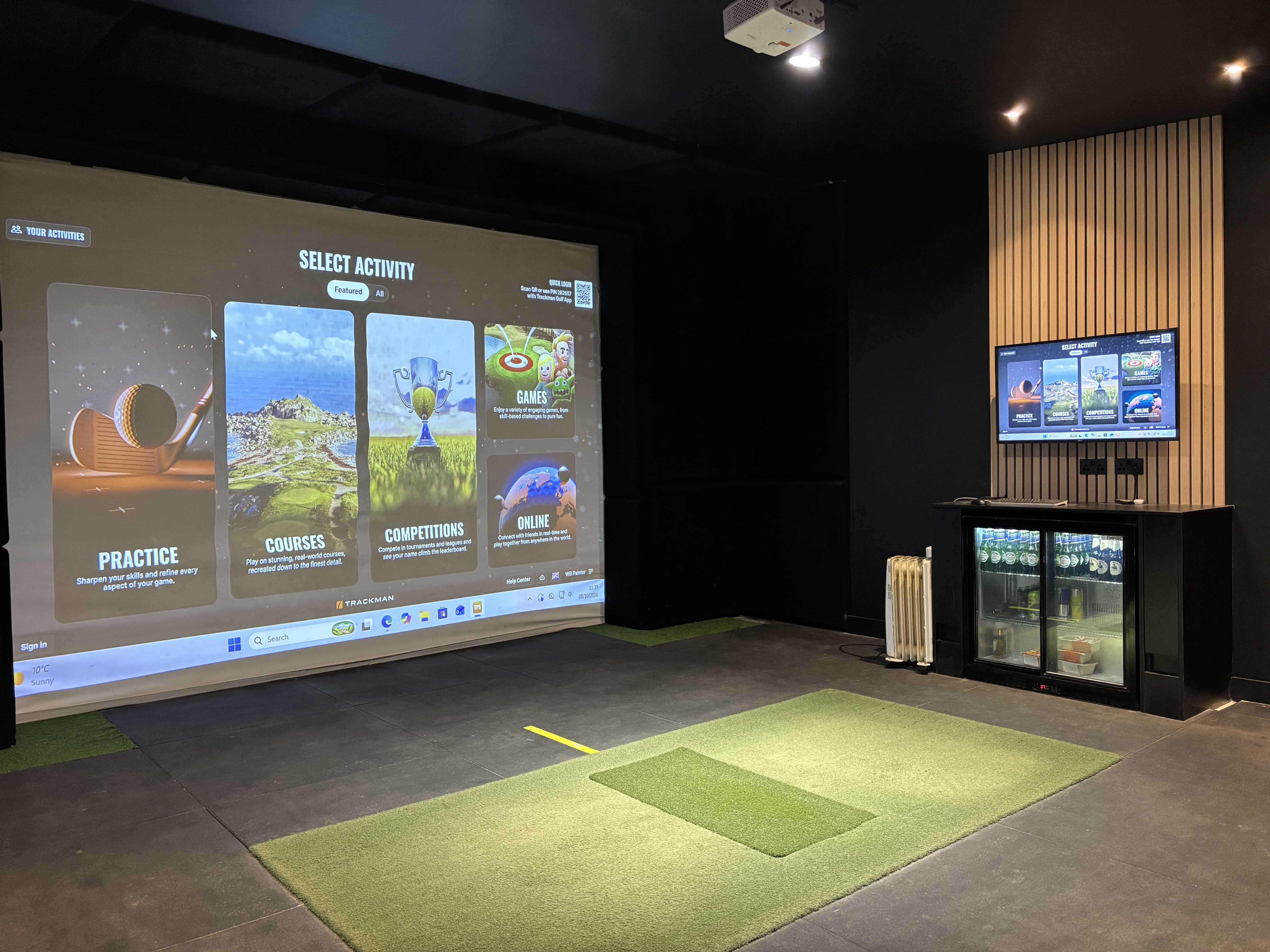 TrackMan driving range bay screen showing the Select Activity menu with a golfer hitting from a covered bay at Evolution Golf Academy near Derby