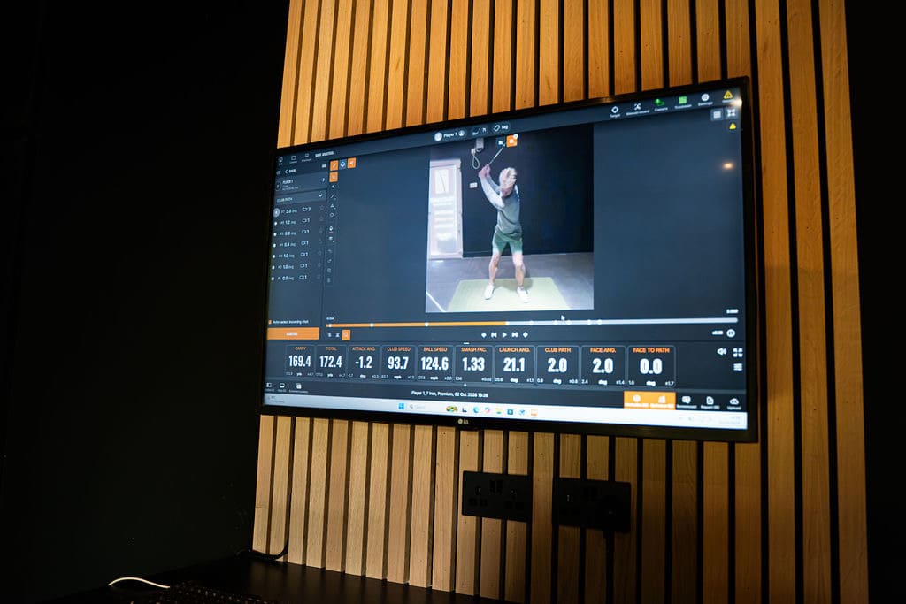 Laptop showing swing video analysis during a golf lesson