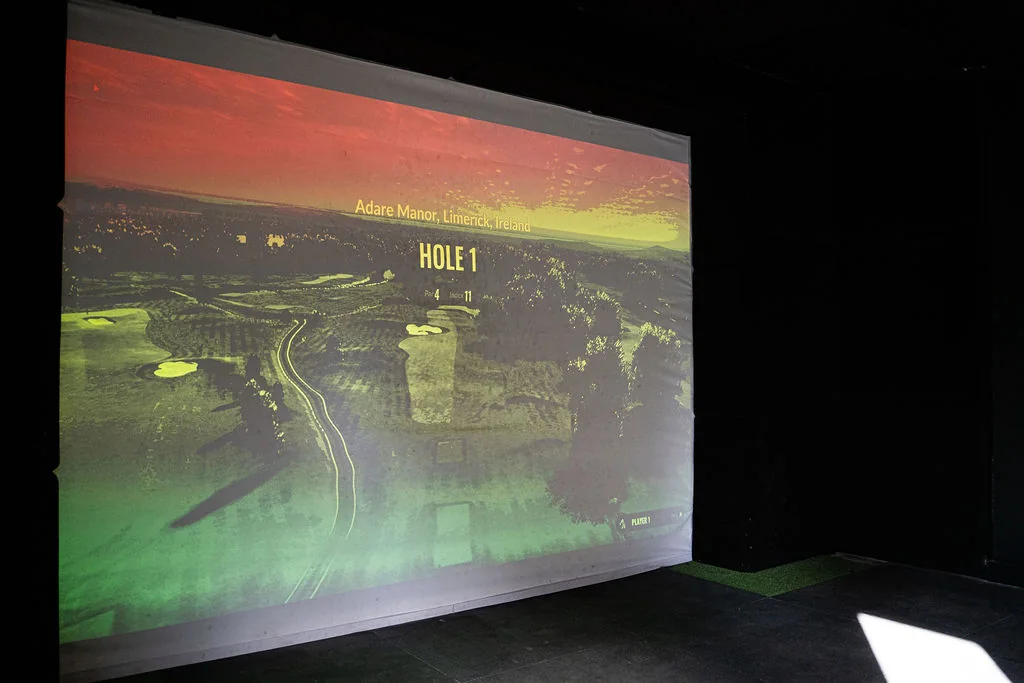 TrackMan simulator course flyover of hole 1 on the projector screen at Evolution Golf Academy near Derby