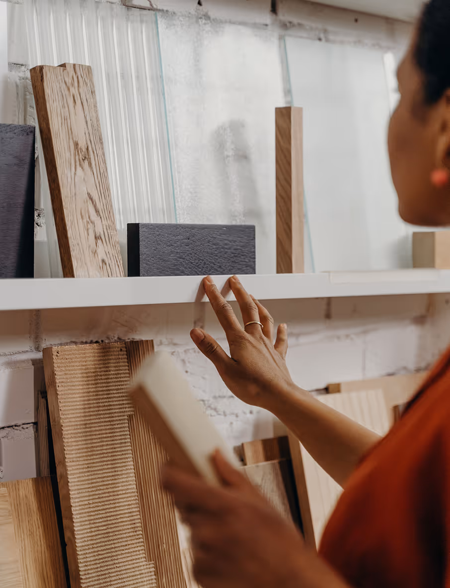 A woman choosing materials from a group of samples