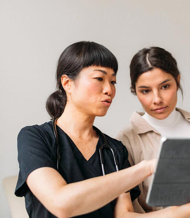 A provider showing a patient their imaging on a tablet.