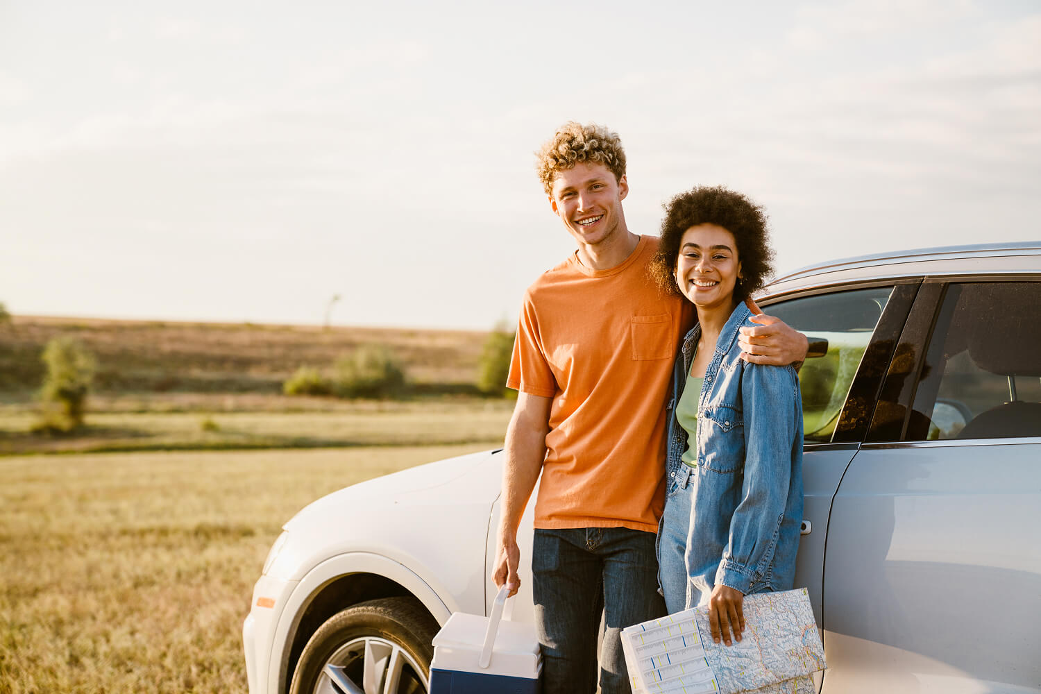Young couple enjoying a road trip on a sunny day.