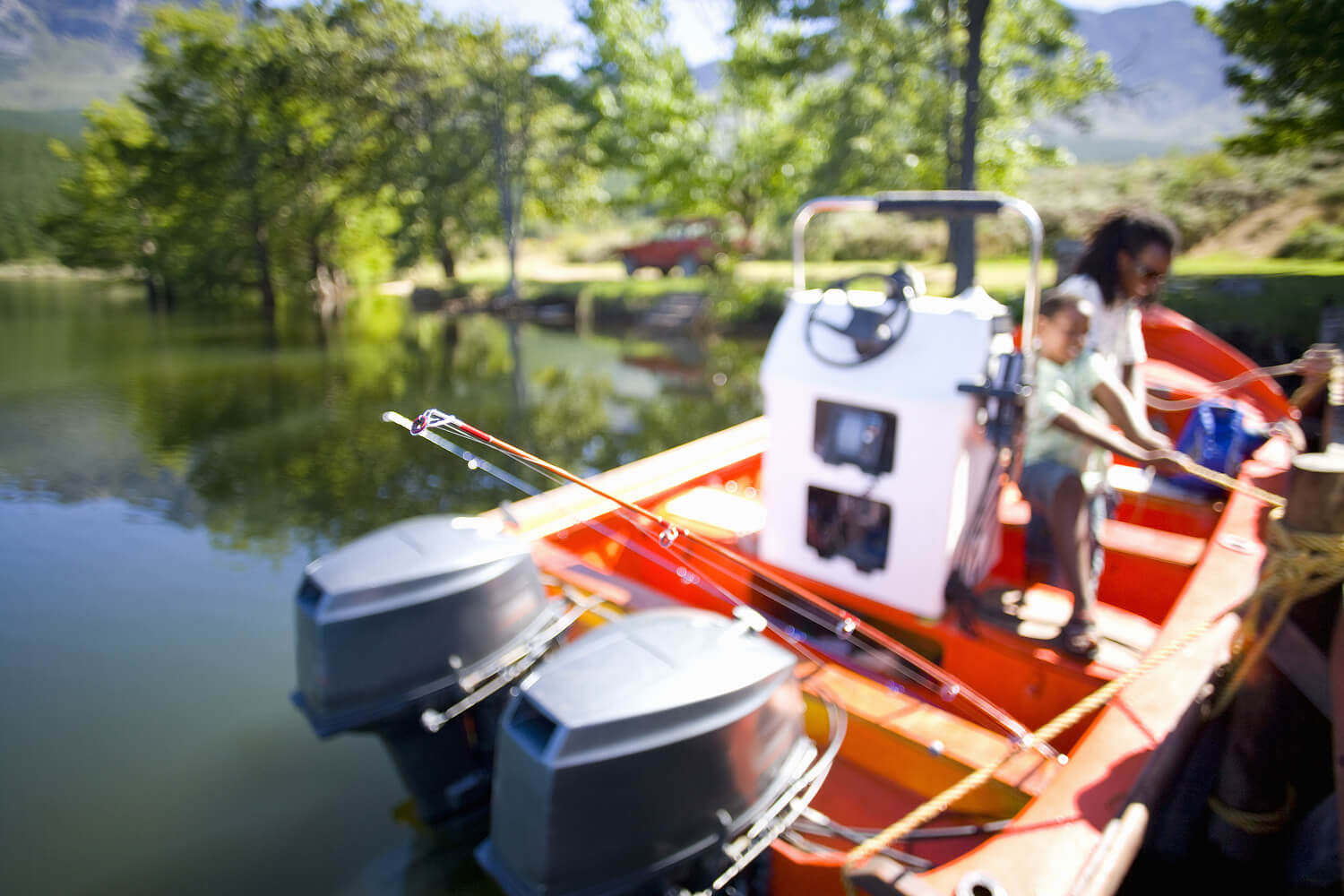 Father and son boating on a lake.