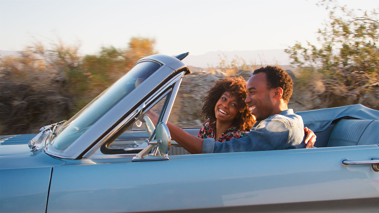 Young couple enjoying a road trip together.