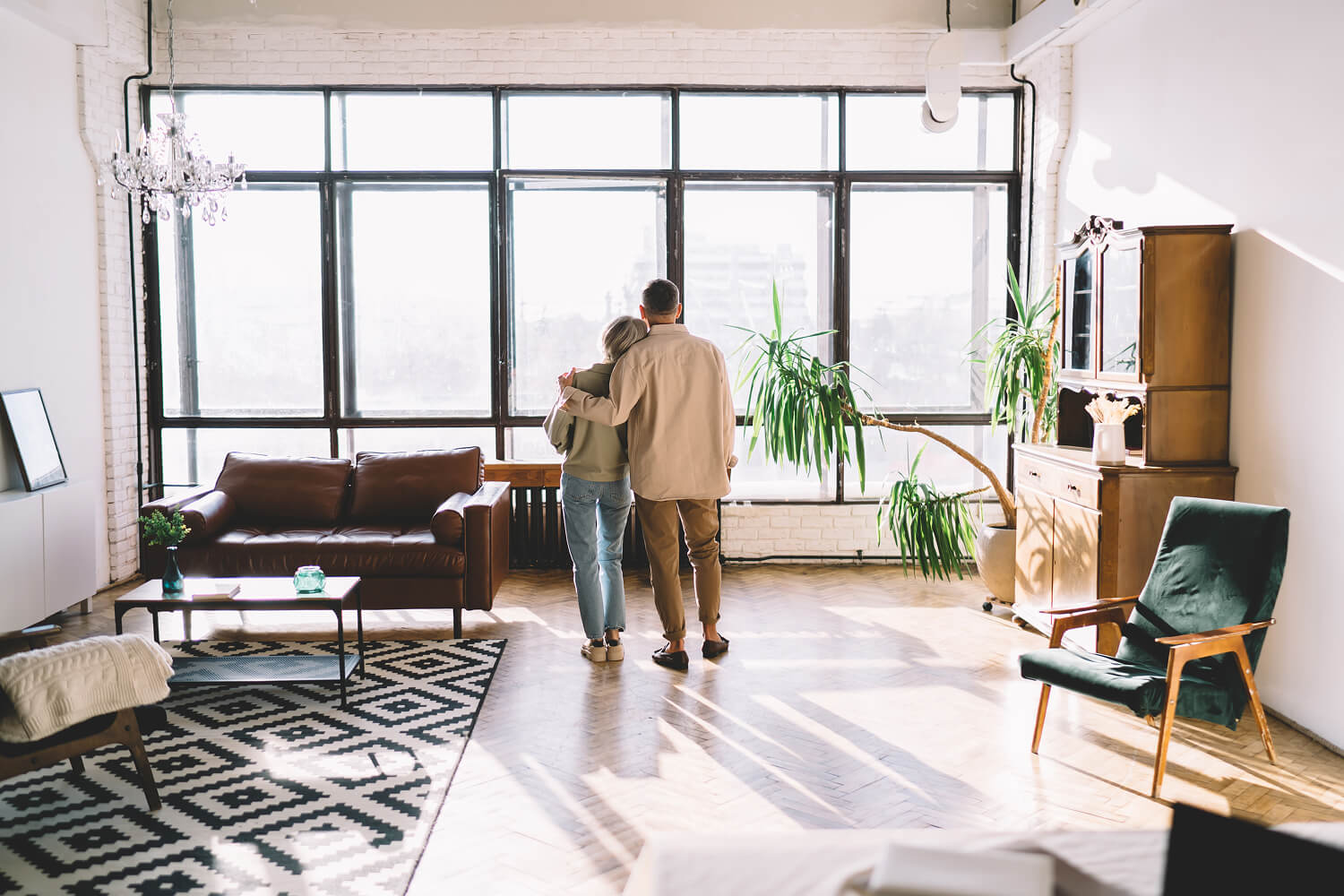 Couple standing together and looking outside.