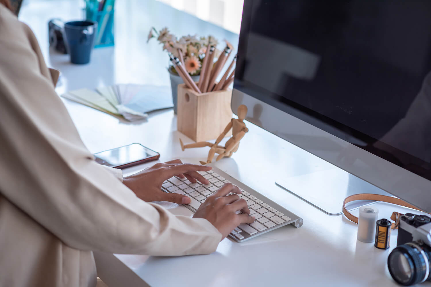 Businesswoman using a computer keyboard at her desk.