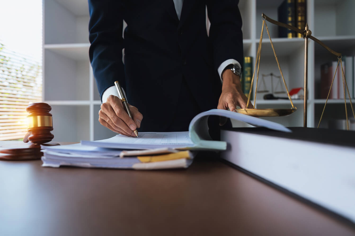 Lawyer reviewing documents while working in an office.