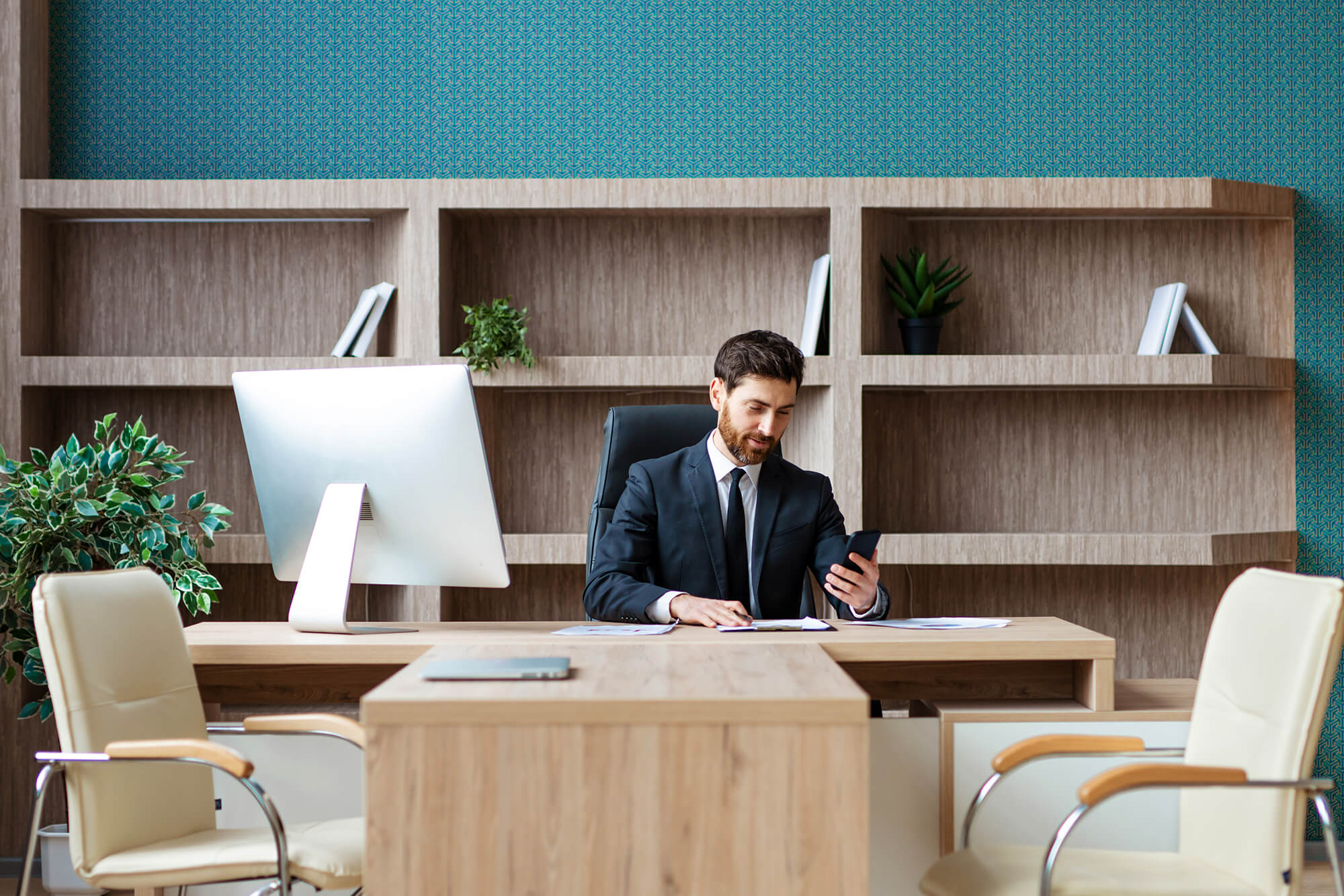 Businessman sitting at a desk working on a computer.