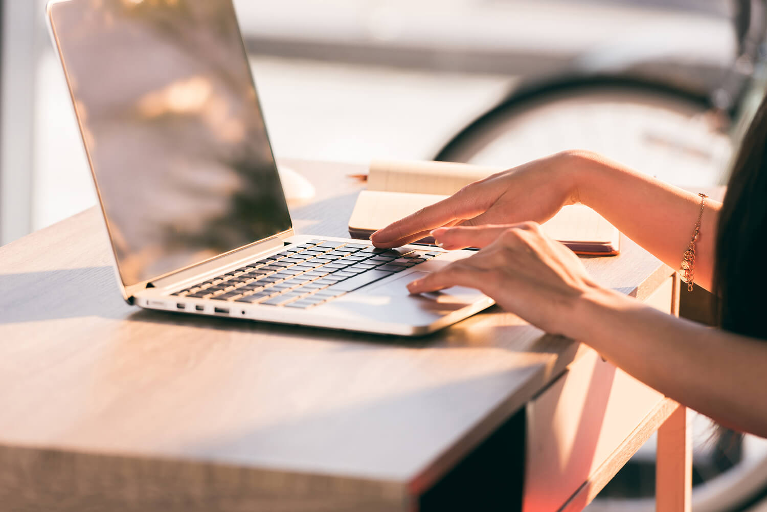 Businesswoman working on a laptop at a desk.