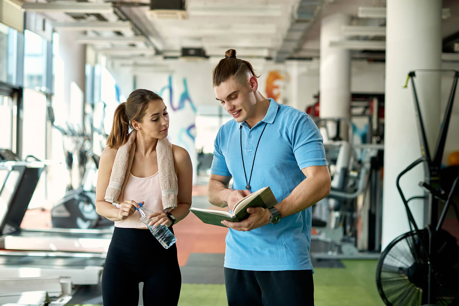 Personal trainer working with a client during a workout.