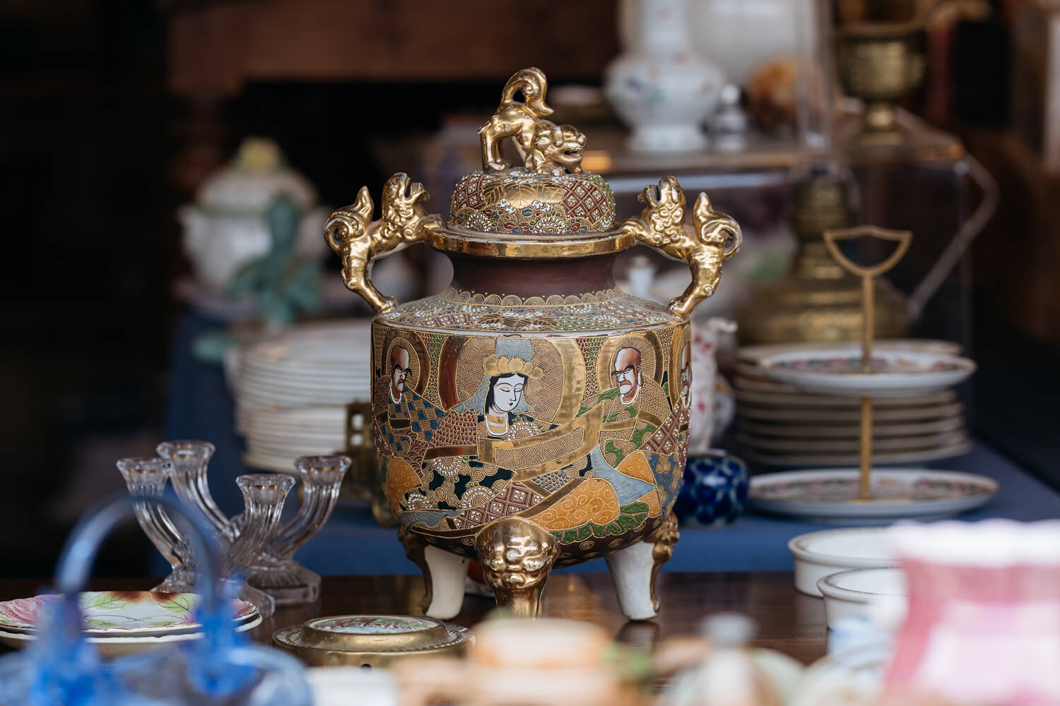 Antique dishes displayed at a flea market.