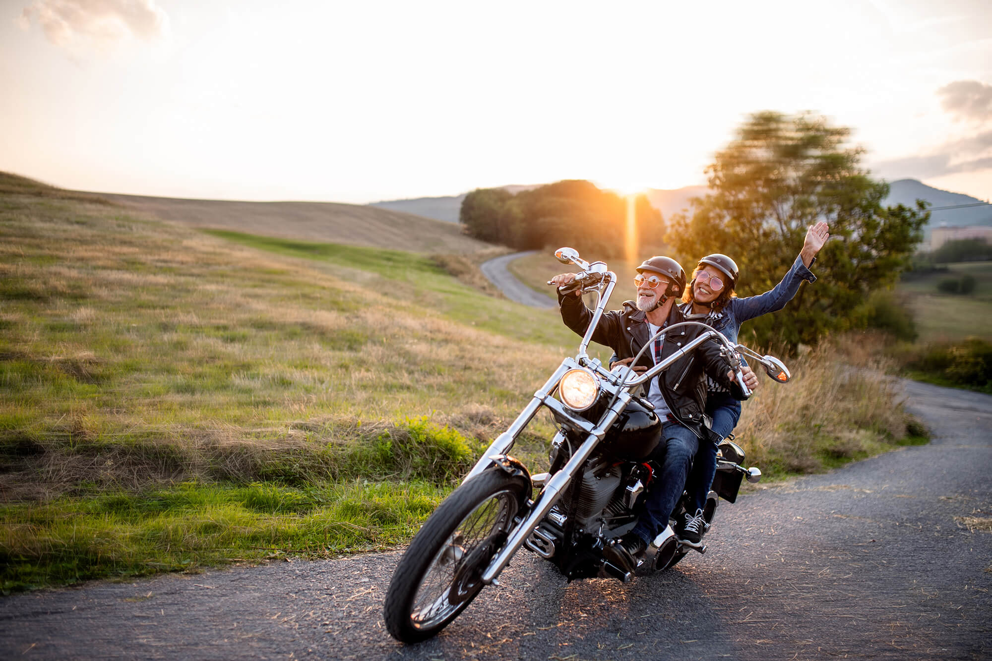 Senior couple enjoying a motorcycle ride in the countryside.
