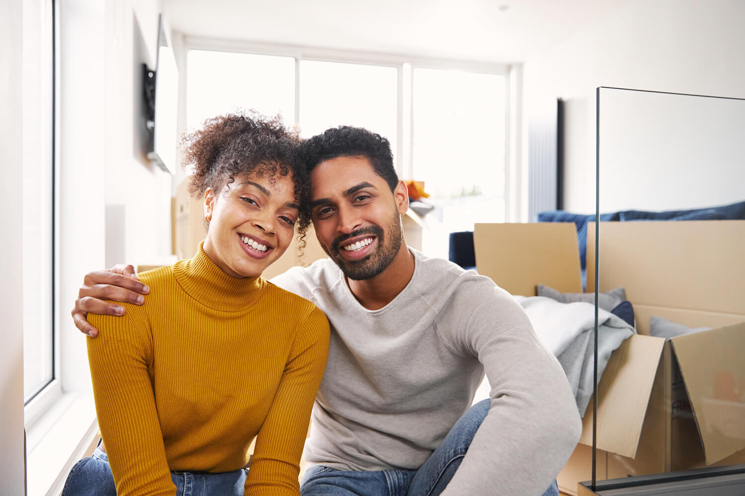 Loving couple in the lounge of their new home.