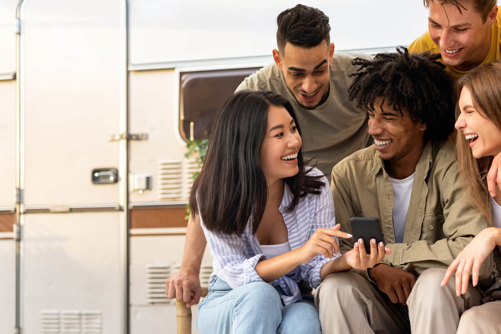 Family enjoying a camping trip beside their RV.