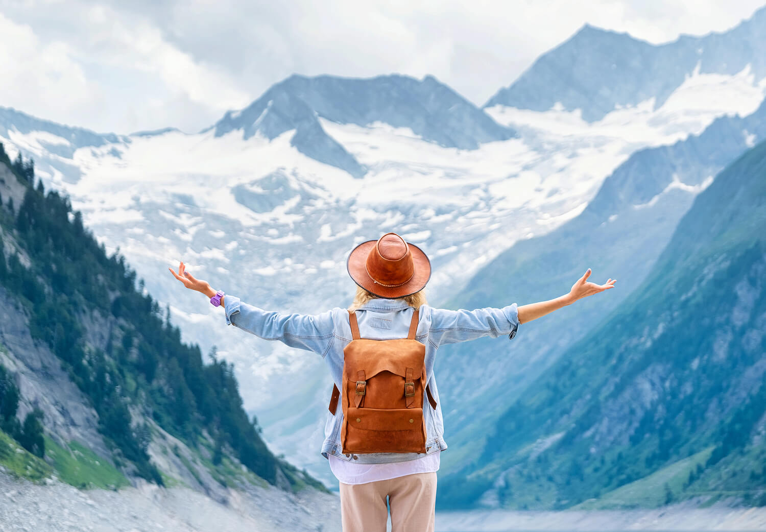Traveler overlooking a scenic mountain valley.