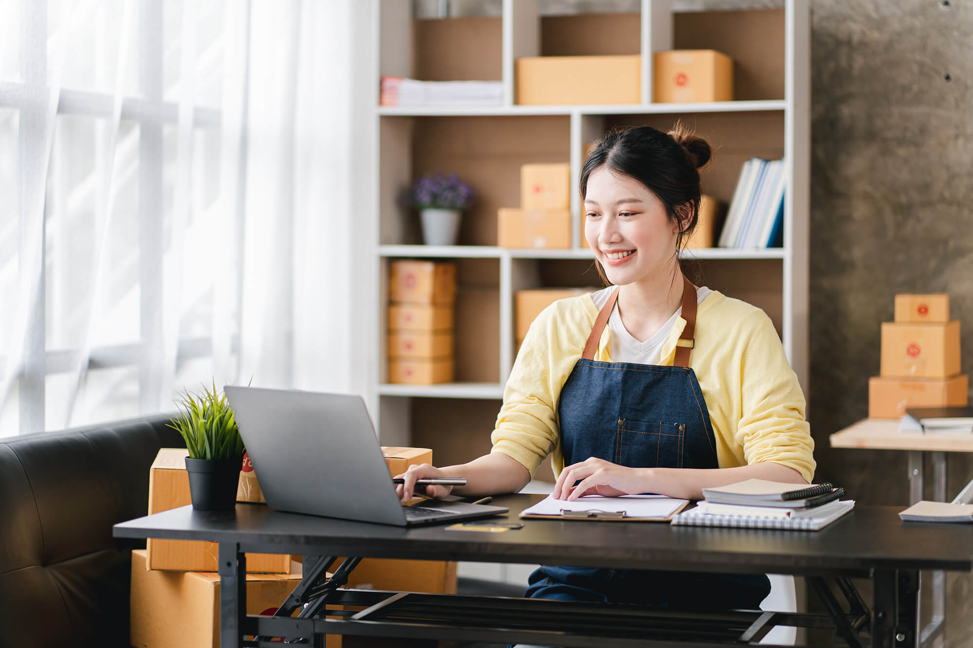 Woman working from home on a laptop at her desk