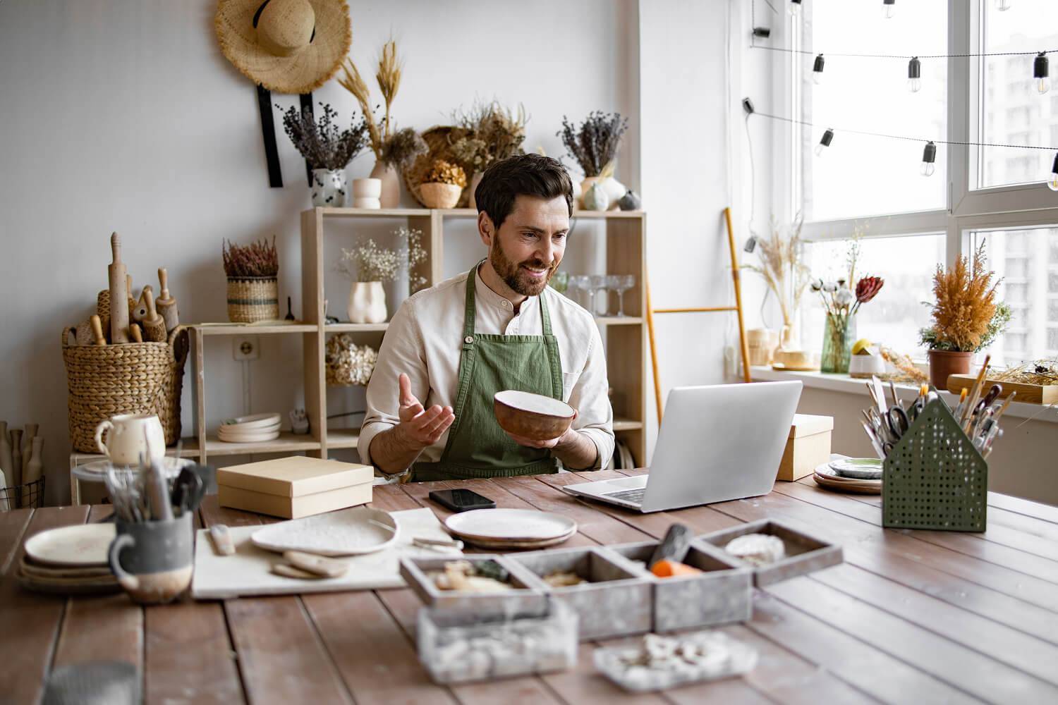 Pottery maker showing handmade ceramics during a video call