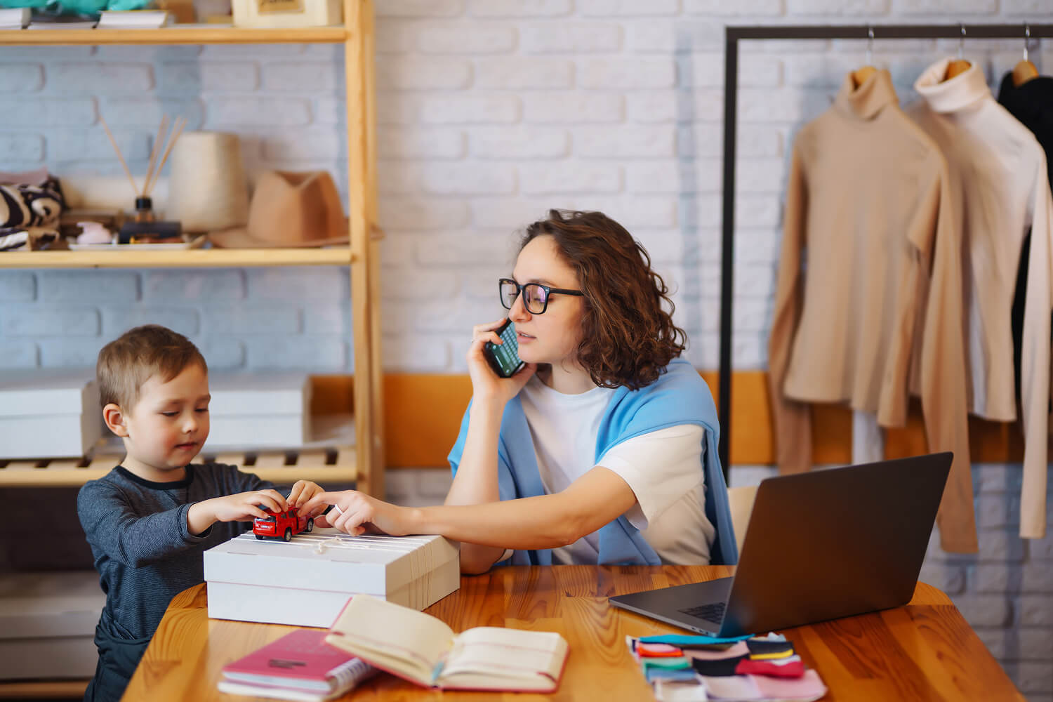 Young mother running a home-based business while caring for her child