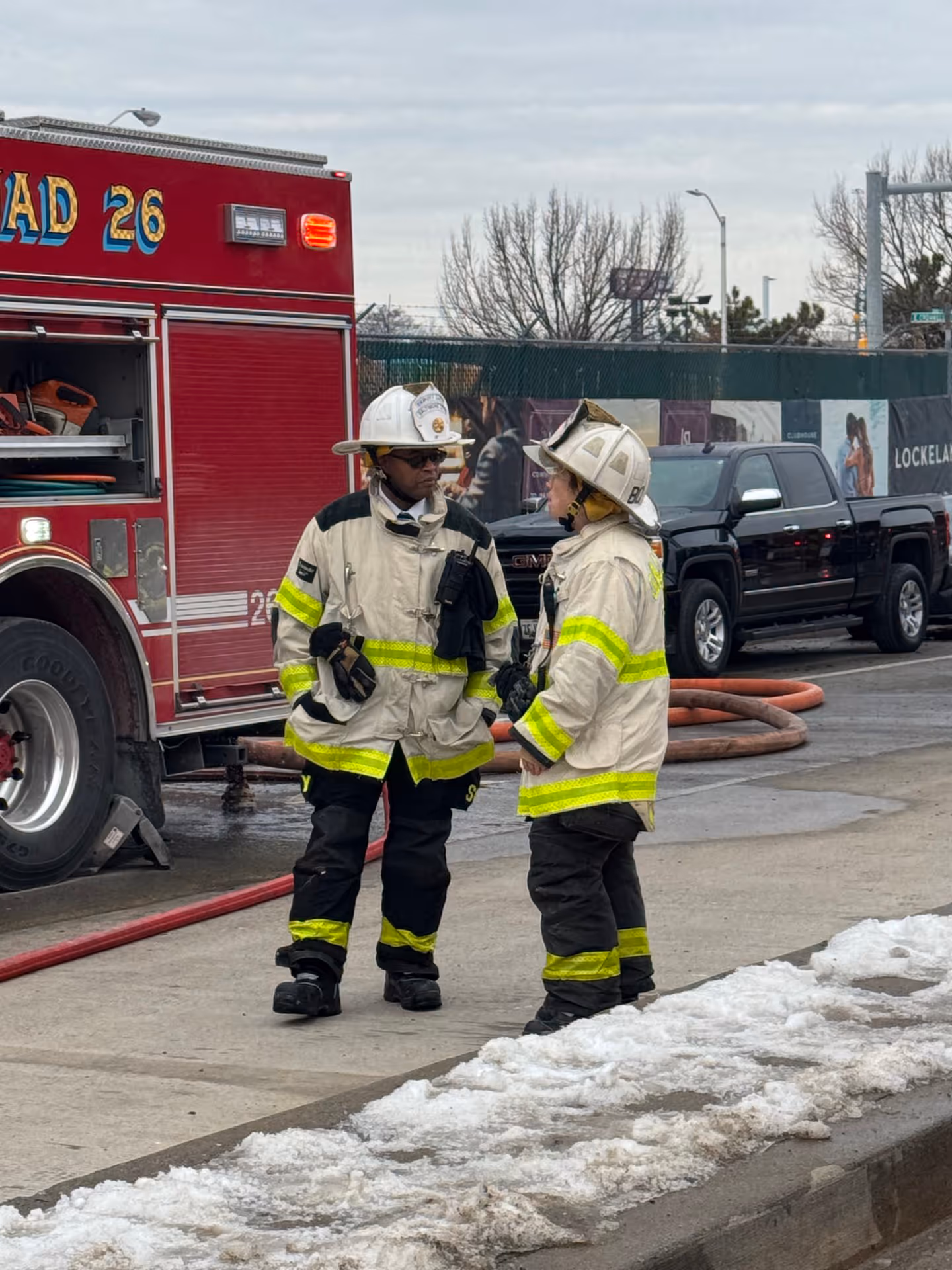 Two firefighters in front of fire truck