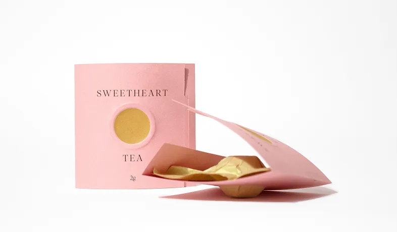 Pink packaging of Sweetheart Tea with a round transparent window showing tea inside.