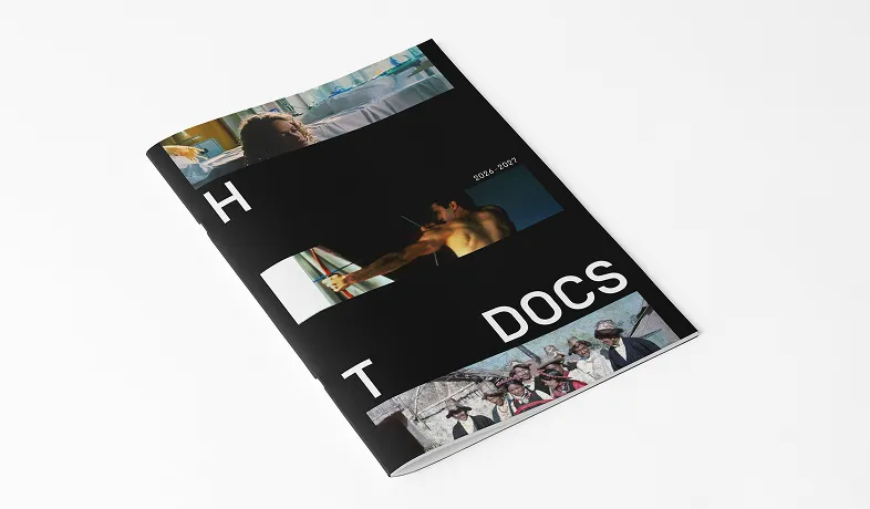 Black magazine titled 'HOT DOCS' with photos of people including a man aiming a bow, against white background.