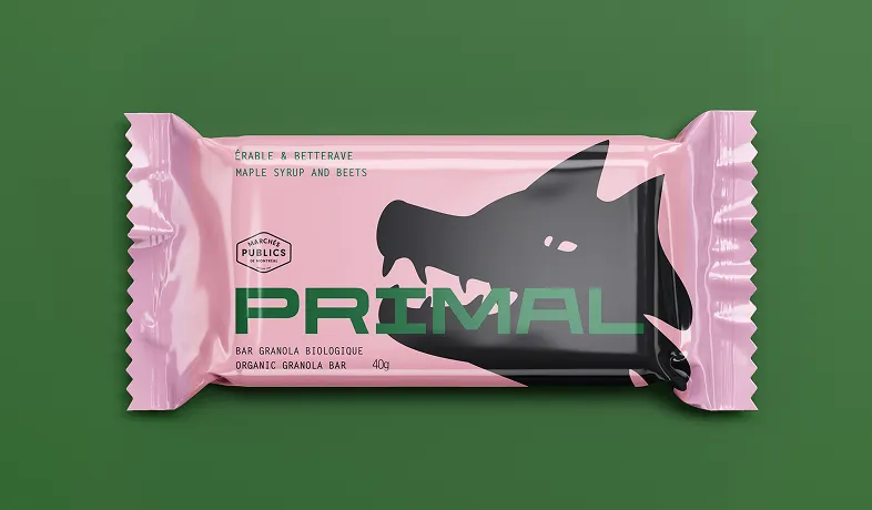 Pink organic granola bar wrapper with black wolf silhouette and green text 'PRIMAL'.