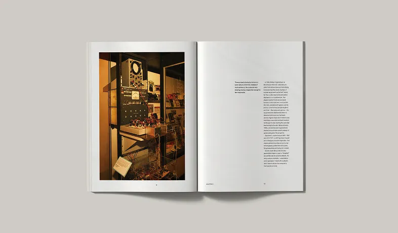 Open book showing text on one page and a photo of vintage electronic equipment in a display case on the other.