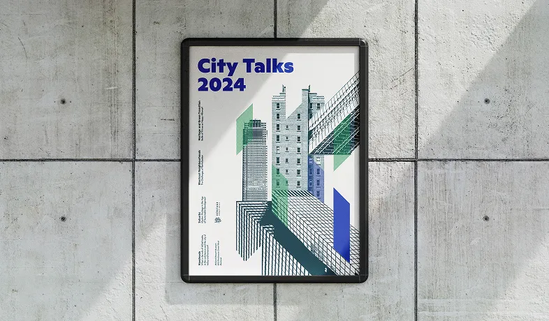 Poster on wall titled City Talks 2024 with abstract illustrations of buildings in blue and green.