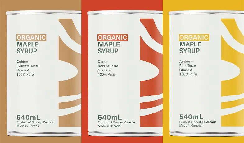 Three 540mL cans of organic maple syrup: golden, dark, and amber, made in Quebec, Canada.