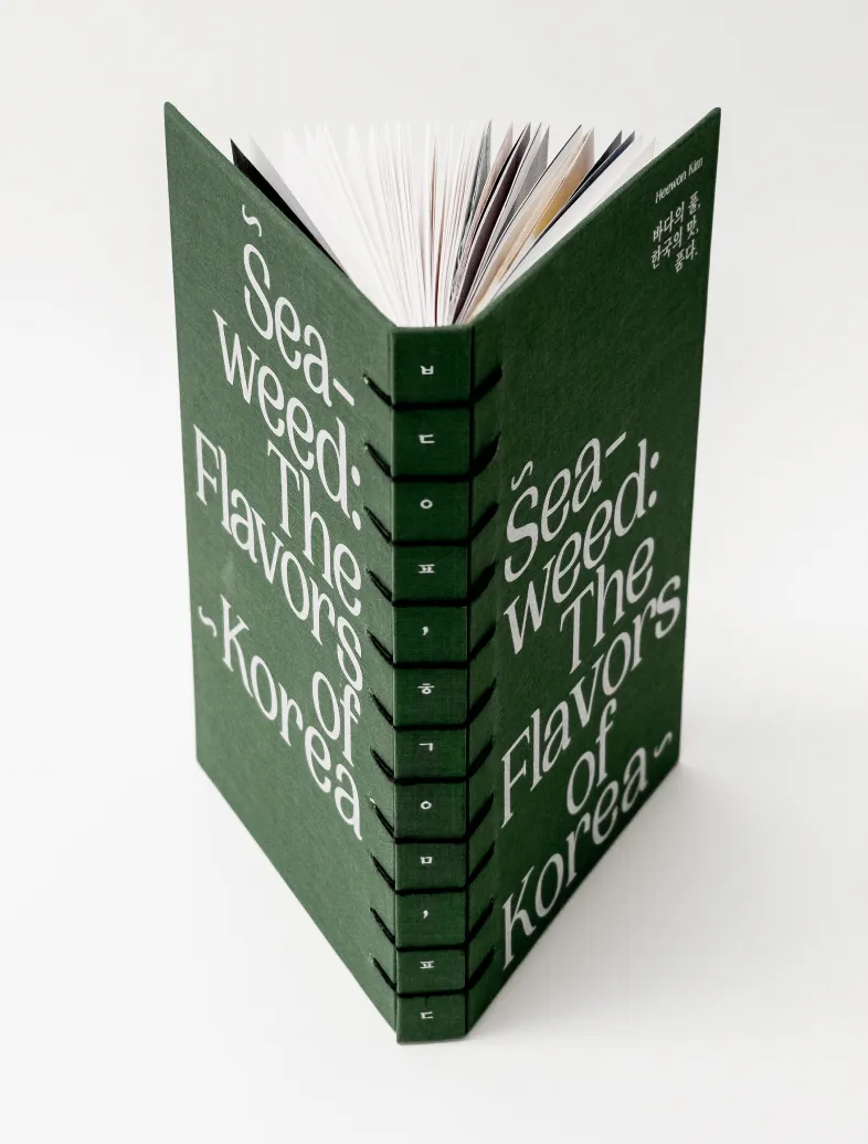 Green hardcover book titled 'Seaweed: The Flavors of Korea' with visible stitched spine binding.