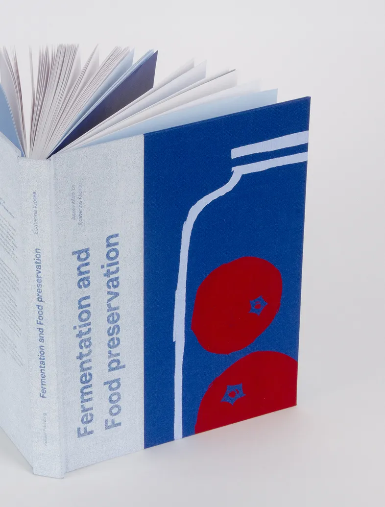 Open book titled 'Fermentation and Food Preservation' with blue cover and red tomato illustration.