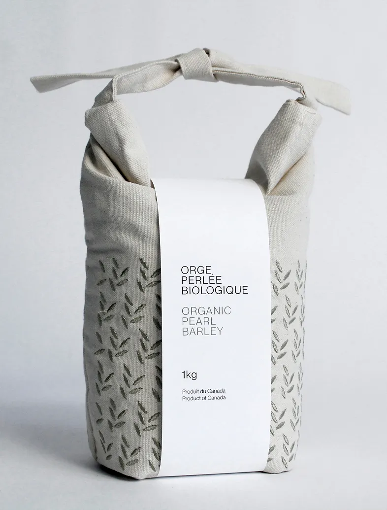 Cloth bag of 1 kg organic pearl barley with green leaf pattern and tied handle.