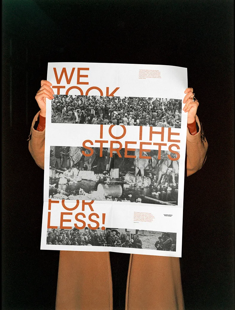 Person holding poster reading 'WE TOOK TO THE STREETS FOR LESS!' with black-and-white protest images.