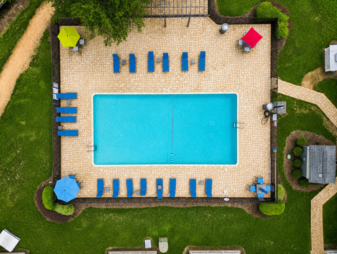 Drone shot of swimming pool with lounge chairs