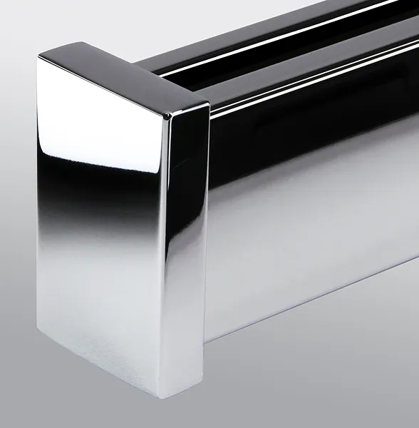 Close-up of a shiny chrome rectangular door handle with a modern design.