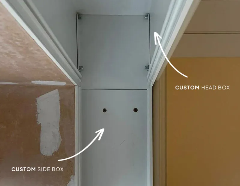 Custom painted head box and side box installed at the top corner of a wall near ceiling trim.