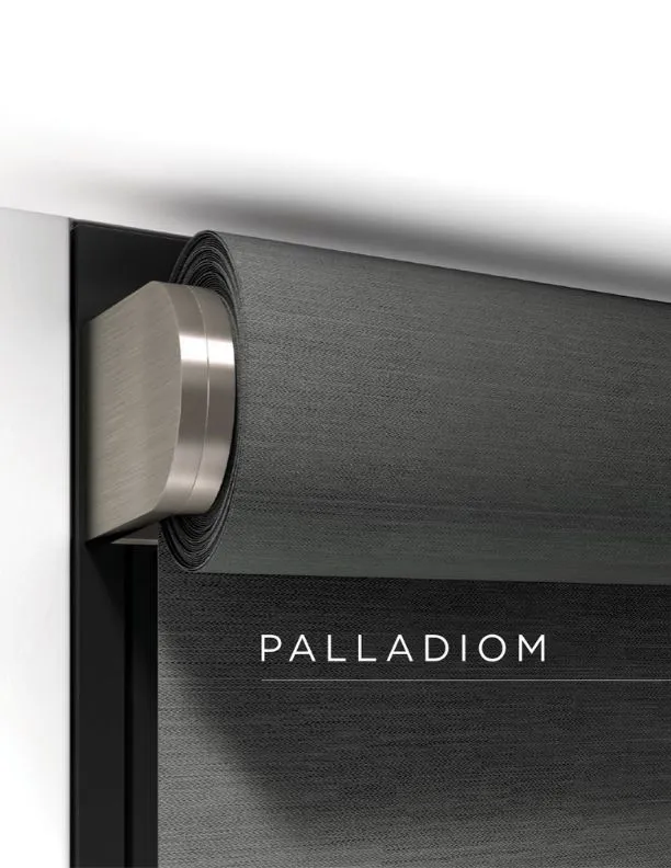 Close-up of a gray rolled window shade mounted on a metallic bracket labeled Palladiom.
