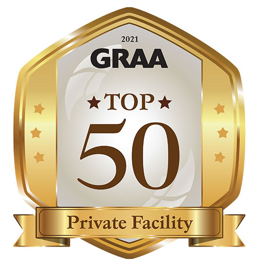 Gold and silver badge labeled '2021 GRAA TOP 50 Private Facility' with stars on the sides and a ribbon at the bottom.