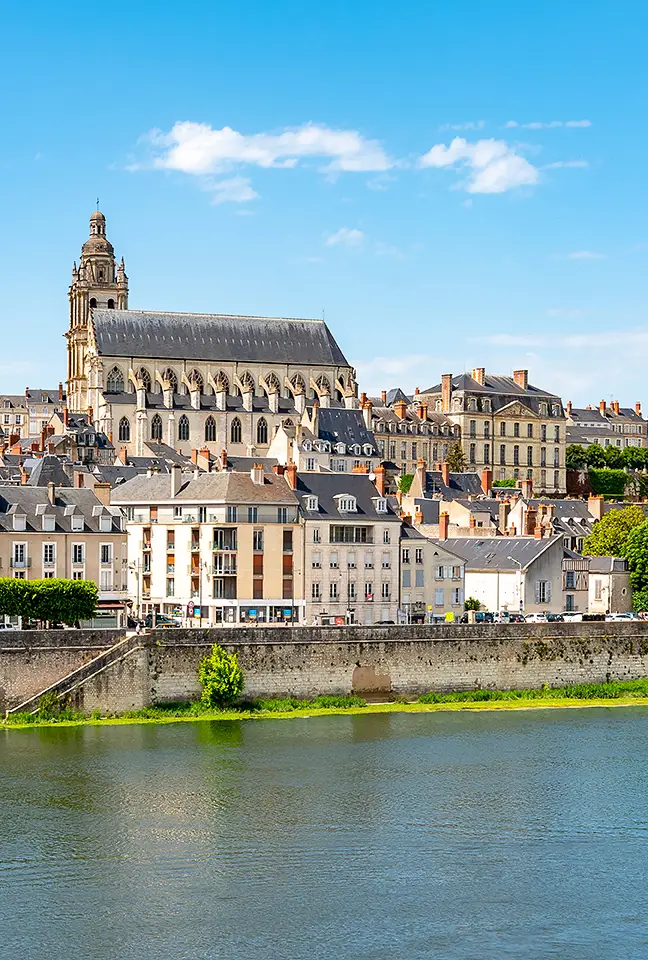The cathedral rises above the old buildings in this river view, not far from Les Hauts de Loire – a 5-star hotel, restaurant, and spa.