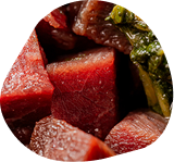 Diced fresh raw meat with greens, close up